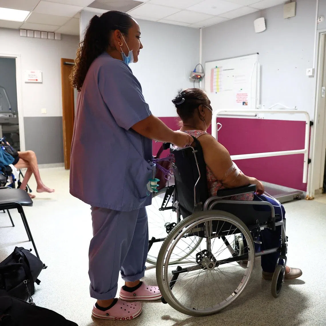 A nurse assists a patient at the Manhes Private Hospital in Fleury-Merogis near Paris during a heatwave affecting a majority of the country, France, June 25, 2026. REUTERS/Abdul Saboor
