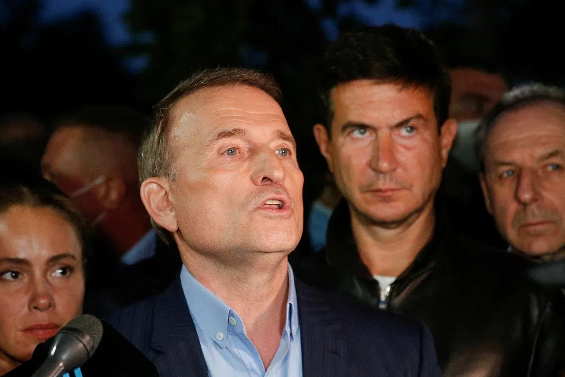 FILE PHOTO: Viktor Medvedchuk talks to the media after a court hearing in Kyiv, Ukraine May 13, 2021. A Ukrainian court ordered Medvedchuk to be placed under house arrest after prosecutors opened an investigation that suspects him of treason. REUTERS/Valentyn Ogirenko/File Photo