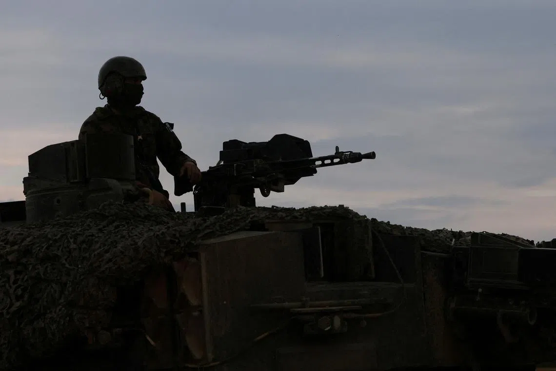 FILE PHOTO: A recruit of the Swiss army Tank School 21 performs an attack exercise with the Leopard 2 tank in Bure, Switzerland May 5, 2023. REUTERS/Denis Balibouse/File Photo