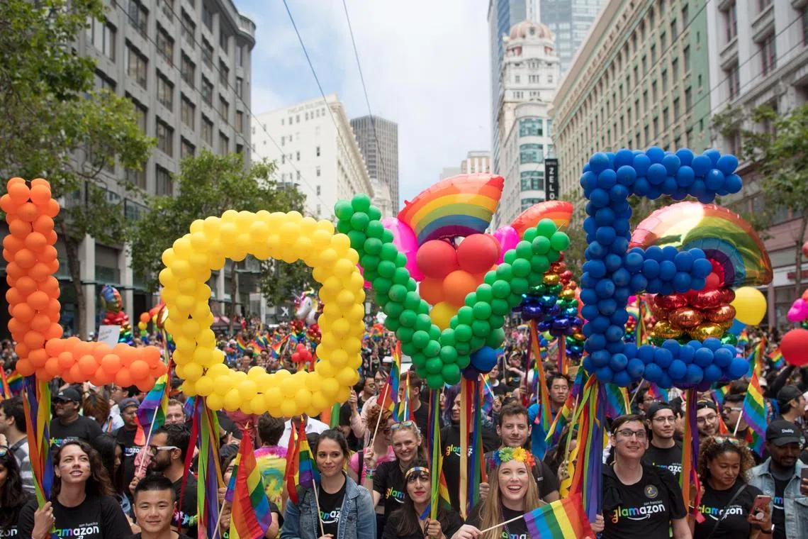 (FILES) People participate in the San Francisco Pride parade in San Francisco, California on June 25, 2017. The organizer of this year's 2025 San Francisco Pride didn't expect rejection when she contacted sponsors, but amid US President Donald Trump's anti-diversity offensive, several longtime backers have withdrawn their support. "It was quite frightening," said Suzanne Ford, executive director of the California-based group which is among America's most influential gay rights organizations. "In about a week and a half period, several corporations came back and said 'We're not sponsoring this year,'" she told AFP.  Several US companies have opted to stop financially supporting organized events, especially those in June, designated as LGBTQ Pride Month. (Photo by Josh Edelson / AFP)