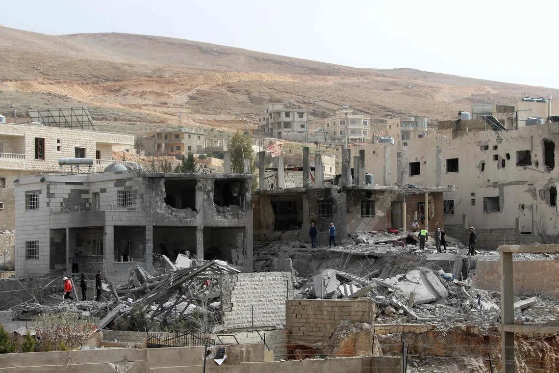 Lebanese Red Cross members inspect the site of an Israeli air strike that targeted the village of Douris in the Bekaa valley on March 12.