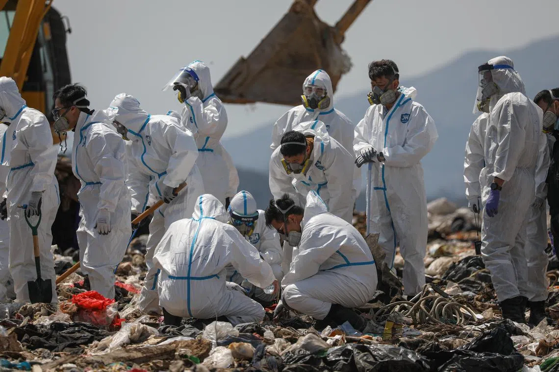 epa10494750 Police officers comb through garbage, searching for the remains of murdered model and influencer Abby Choi in a landfill site in Hong Kong, China, 28 February 2023. Choi’s gruesome murder came to light last week after police found two severed legs, believed to be hers, inside a flat, followed by a skull and several ribs discovered in a large soup pot seized from the property.  EPA-EFE/JEROME FAVRE