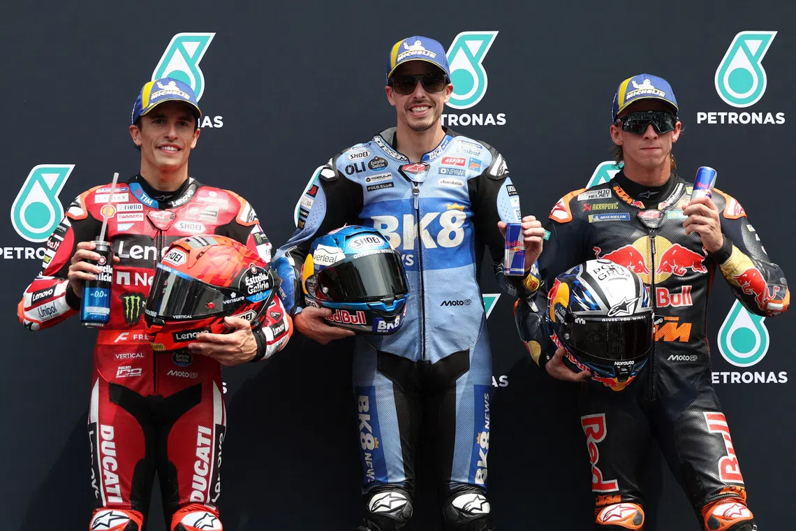Gresini Racing MotoGP’s Alex Marquez celebrates after qualifying in pole position along with second placed Ducati Lenovo Team’s Marc Marquez and third placed Red Bull KTM Factory Racing’s Pedro Acosta.