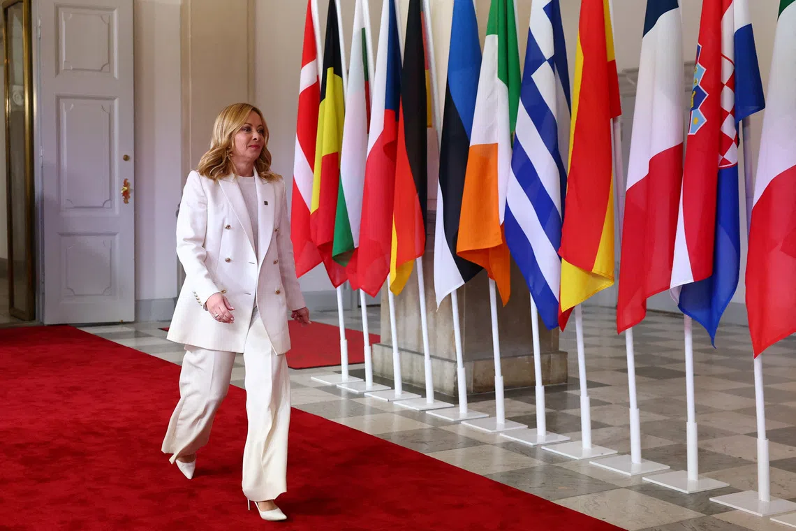 Italy's Prime Minister Giorgia Meloni walks as she is welcomed by Denmark's Prime Minister Mette Frederiksen (not pictured) on the day of the informal meeting of European Union leaders in Copenhagen, Denmark, October 1, 2025. REUTERS/Piroschka van de Wouw