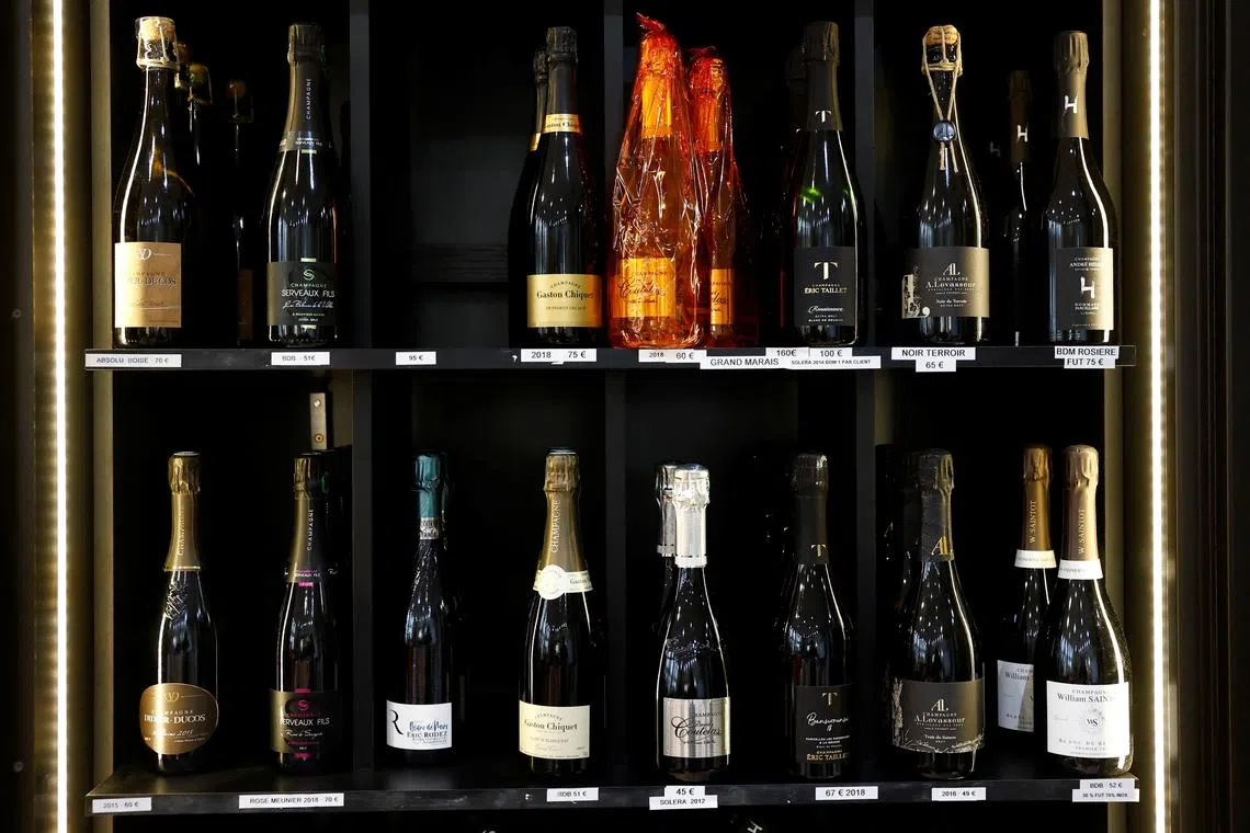 Bottles of Champagne are seen on display for sale in a wine shop in Paris, France, March 13, 2025. REUTERS/Stephanie Lecocq
