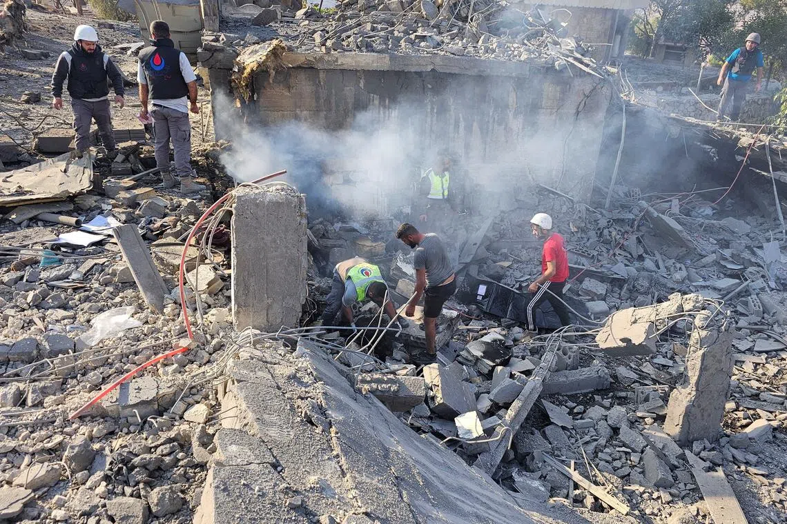 Rescuers work at a site damaged in the aftermath of an Israeli strike in Sohmor, in Lebanon's Bekaa Valley, October 30, 2024. REUTERS/Maher Abou Taleb