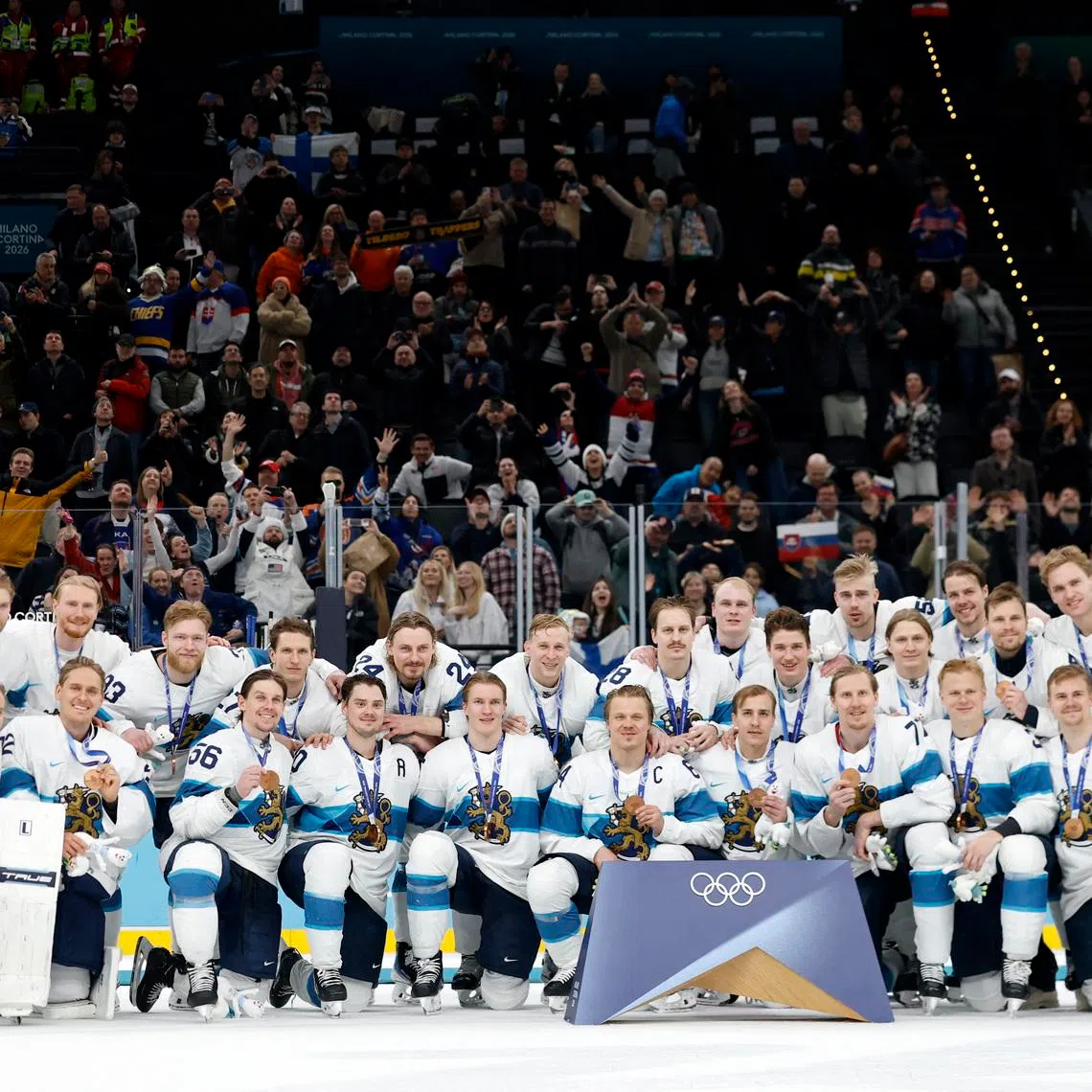 Milano Cortina 2026 Olympics - Ice Hockey - Men's Bronze Victory Ceremony - Milano Santagiulia Ice Hockey Arena, Milan, Italy - February 21, 2026. Bronze medallists Finland pose for a team group photo during the bronze victory ceremony. REUTERS/David W Cerny