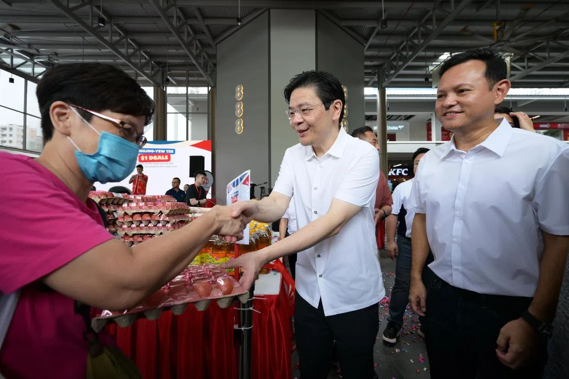 PM Lawrence Wong with MP Mr. SMS Zaqy Mohamad at the launch of Marsiling-Yew Tee GRC?s MY $1 Deals at 888 Plaza on Jan 18, 2025.