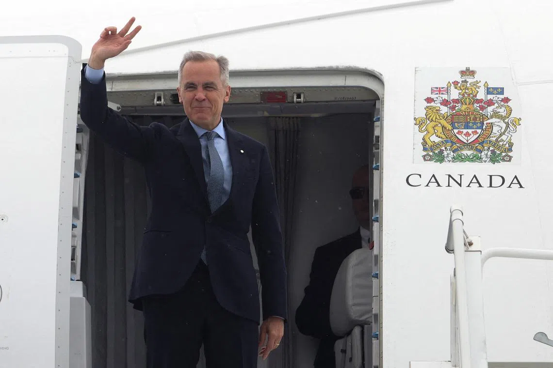 FILE PHOTO: Canada's Prime Minister Mark Carney waves as he boards his plane for Washington, D.C., in Ottawa, Ontario, Canada, May 5, 2025.  REUTERS/Patrick Doyle/File Photo