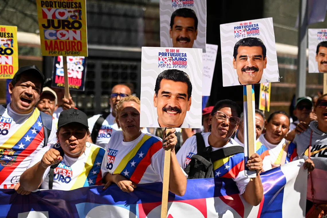 Supporters of Venezuela's President Nicolas Maduro cheer as he is being sworn in for a third six-year term, in Caracas, Venezuela January 10, 2025. REUTERS/Maxwell Briceno