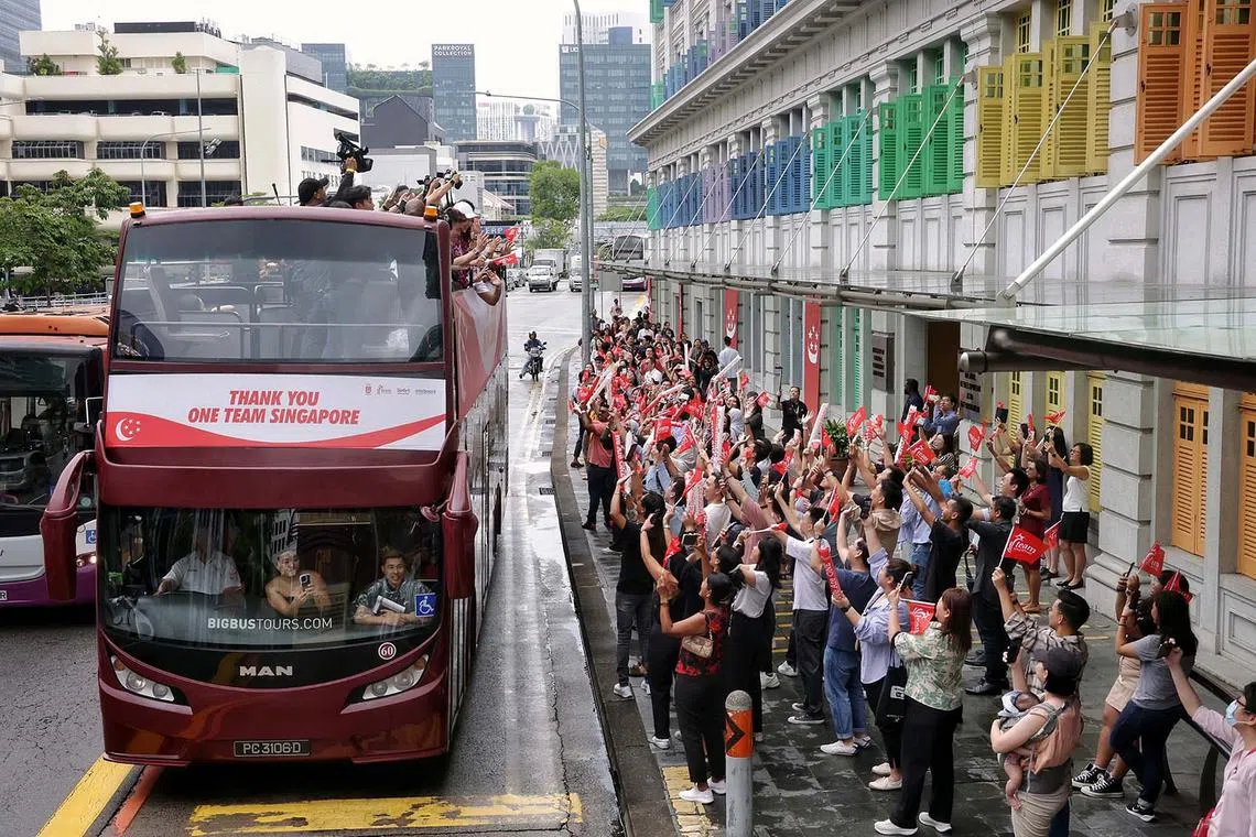 Supporters in Hill Street waving at the Olympians during the One Team Singapore celebratory parade on Aug 14, 2024. ST PHOTO: KEVIN LIM dgbus14