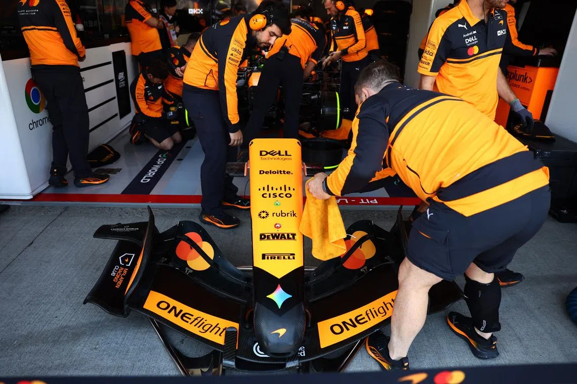 Formula One F1 - Japanese Grand Prix - Suzuka Circuit, Suzuka, Japan - March 27, 2026 An engineer works on the front wing of the car of McLaren's Lando Norris in the garage during the first practice session REUTERS/Issei Kato