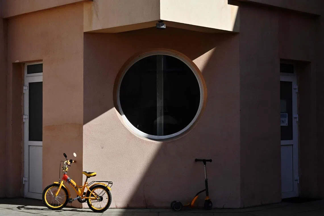 A child's bicycle and scooter parked near a kindergarten in Kyiv on March 20.