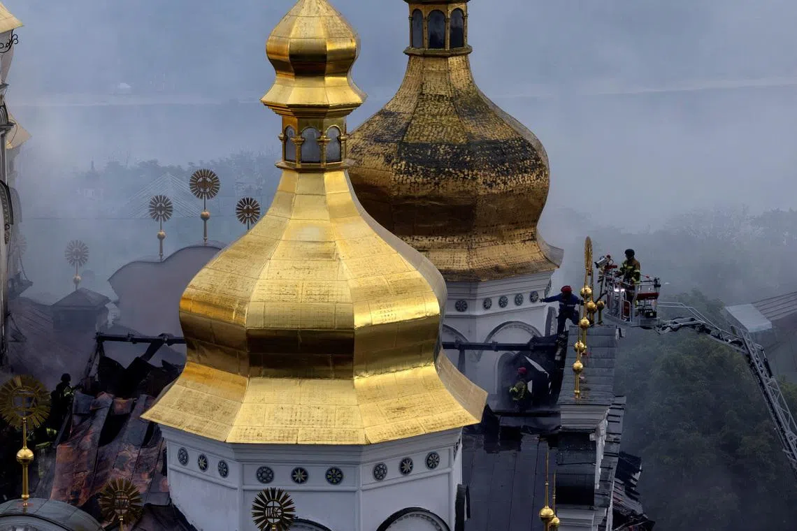 Emergency workers extinguish a fire on the roof of the Dormition Cathedral of the Kyiv Pechersk Lavra, after it was hit during Russian missile and drone strikes, amid Russia's attack on Ukraine, in Kyiv, Ukraine June 15, 2026.  REUTERS/Thomas Peter