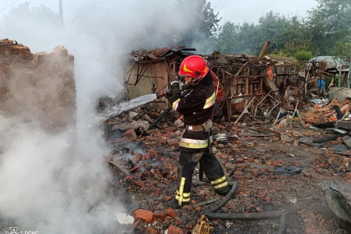 A firefighter working at the site of a Russian drone strike in the town of Pryluky, Ukraine. The town's firefighting chief was responding to an earlier attack when his own house was hit by a Russian drone, killing his wife, daughter and baby grandson.