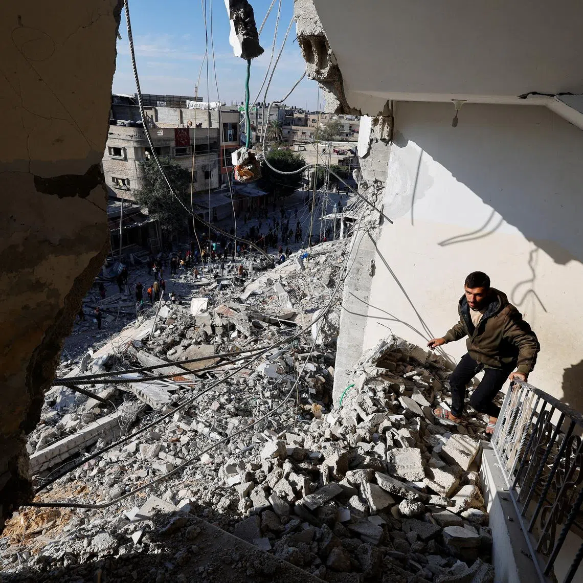 FILE PHOTO: A Palestinian man walks through the rubble of a building damaged in an Israeli air strike, amid the ongoing conflict between Israel and the Palestinian Islamist group Hamas, in Rafah, in the southern Gaza Strip March 9, 2024. REUTERS/Mohammed Salem/File Photo
