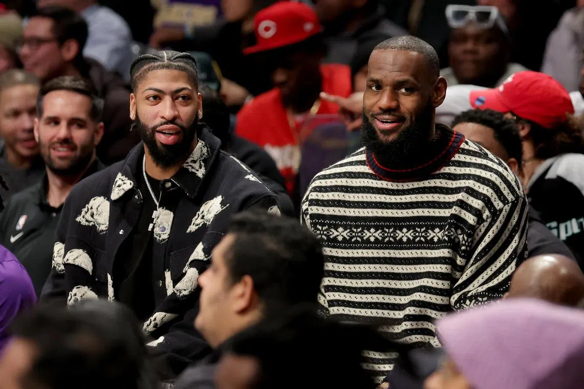 Los Angeles Lakers forwards Anthony Davis (left) and LeBron James watch from the bench during the second quarter against the Brooklyn Nets at Barclays Centre.