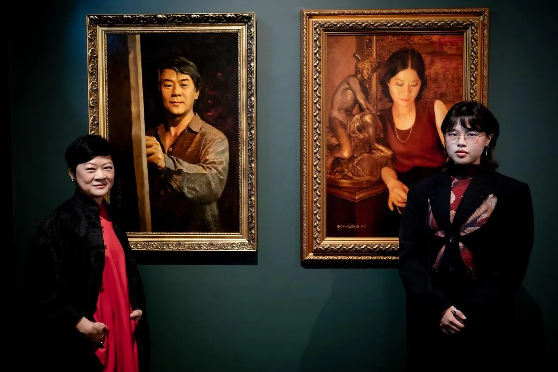 Dr Chua Yang and her niece Ernestine Chua with portraits of Chua Mia Tee and Lee Boon Ngan.