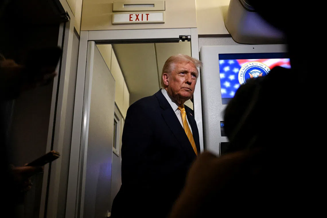 U.S. President Donald Trump talks to members of the press on board Air Force One en route to Florida, U.S., November 14, 2025. REUTERS/Annabelle Gordon/File Photo