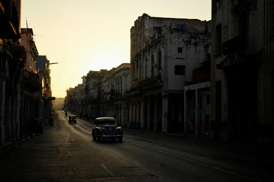 Cars drive on a street during a national electrical grid collapse, in Havana, Cuba, March 15, 2025. REUTERS/Norlys Perez