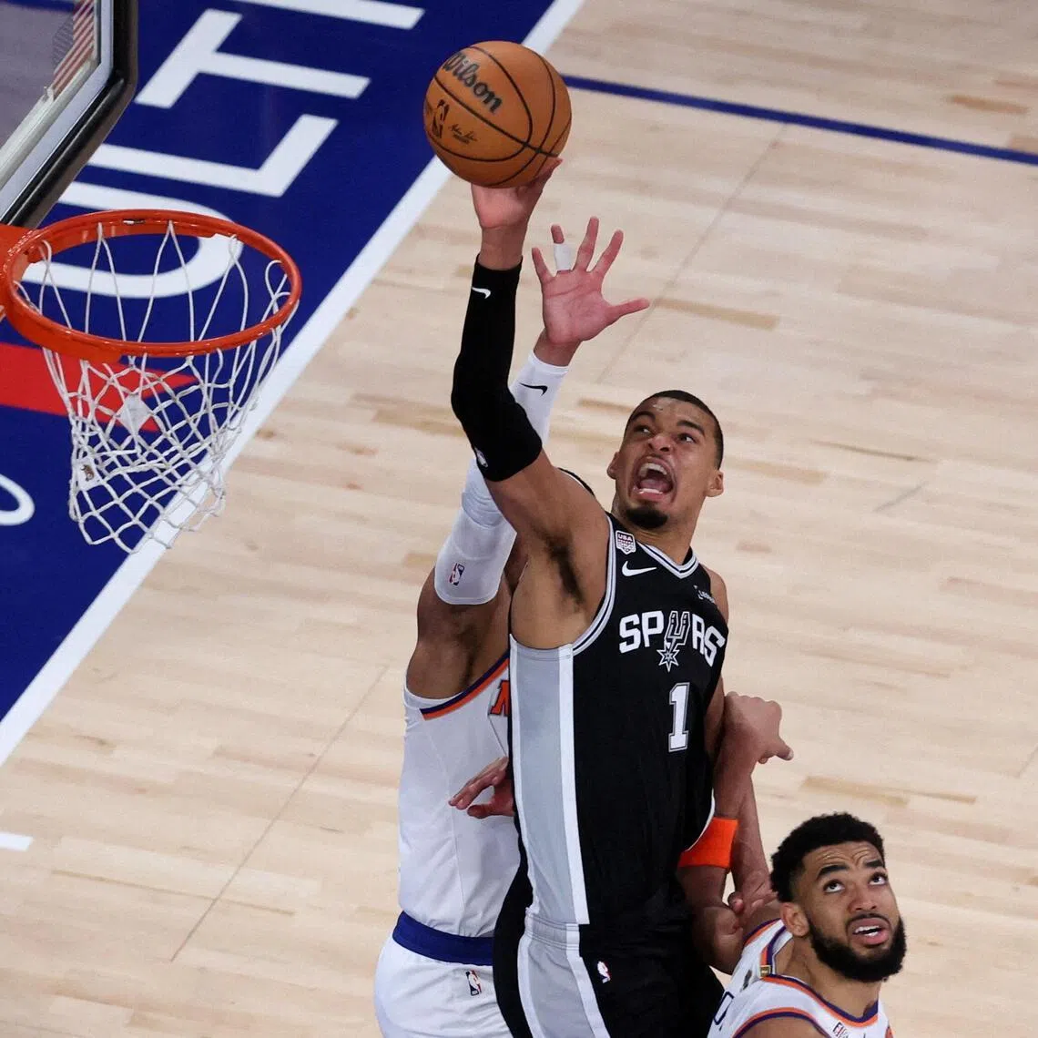 San Antonio Spurs forward Victor Wembanyama shoots the ball against New York Knicks center Karl-Anthony Towns during Game 3.   