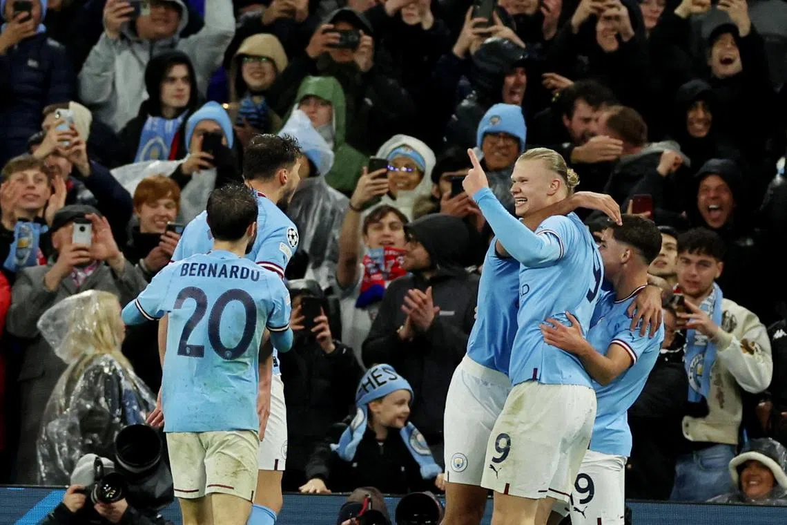 Manchester City's Erling Haaland celebrates scoring their third goal with teammates.