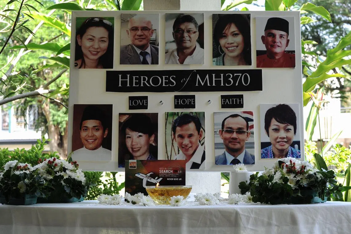 A poster showing cabin crew from the missing Malaysia Airlines flight MH370 is displayed during a prayer at a school in Petaling Jaya on March 8, 2016.