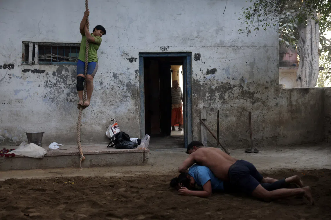 Wrestlers practice at an akhara on the banks of Yamuna river in New Delhi, India, December 10, 2025. REUTERS/Bhawika Chhabra/File Photo