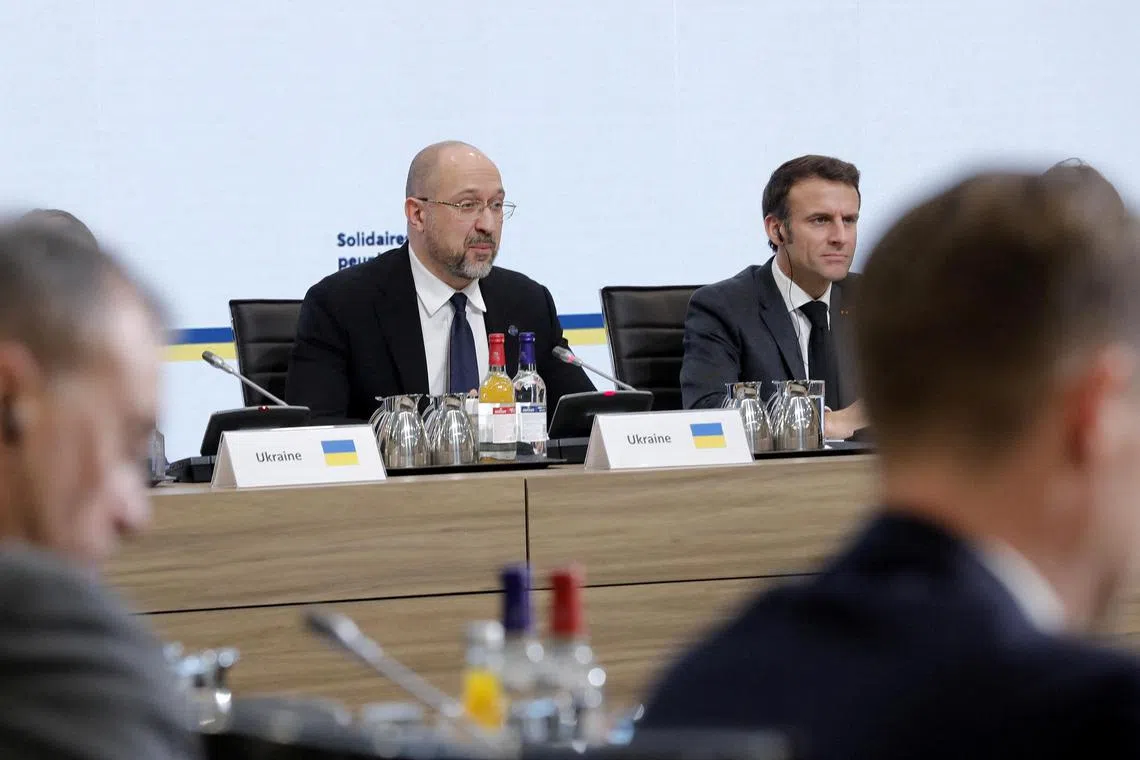 Ukrainian Prime Minister Denys Shmyhal (left) attends a conference in solidarity with the Ukrainian people in Paris, France, in December 2022.