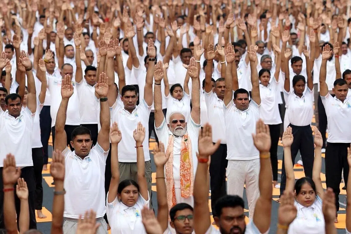 India's Prime Minister Narendra Modi (centre, front) participating in a yoga session on International Day of Yoga in Kolkata on June 21. 