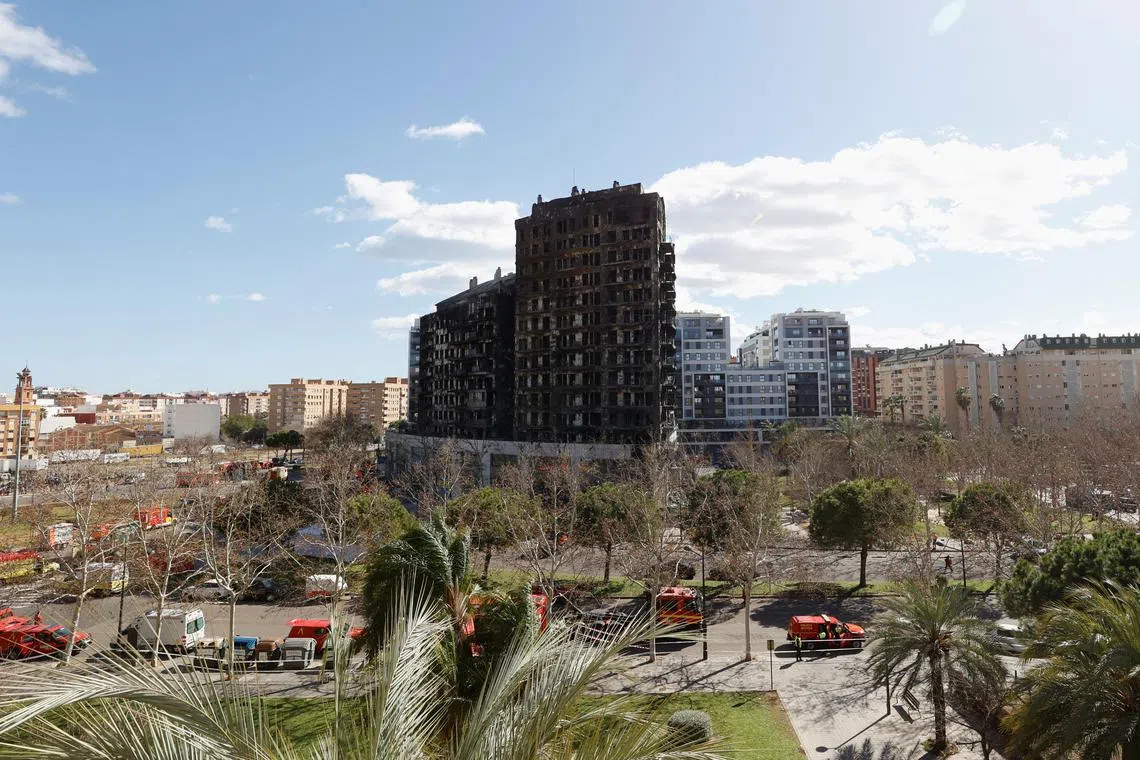 Firetrucks stand at the scene of a fire on an apartment building in Valencia, Spain, February 23, 2024. REUTERS/Eva Manez