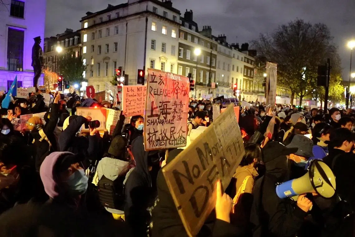 People protesting against China's Covid-19 curbs in front of the Chinese embassy in London on Nov 27.