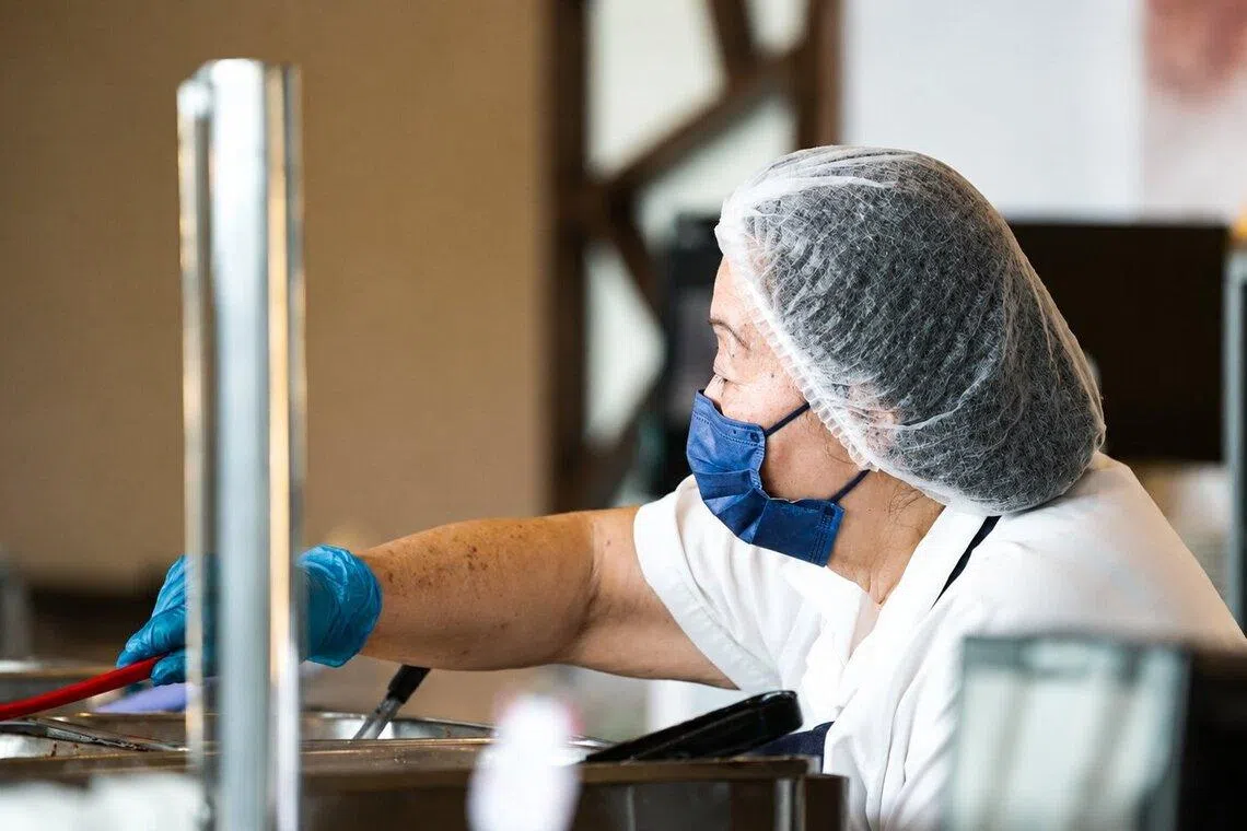 Wong’s responsibilities include serving meals, arranging and replenishing food, and clearing tables.