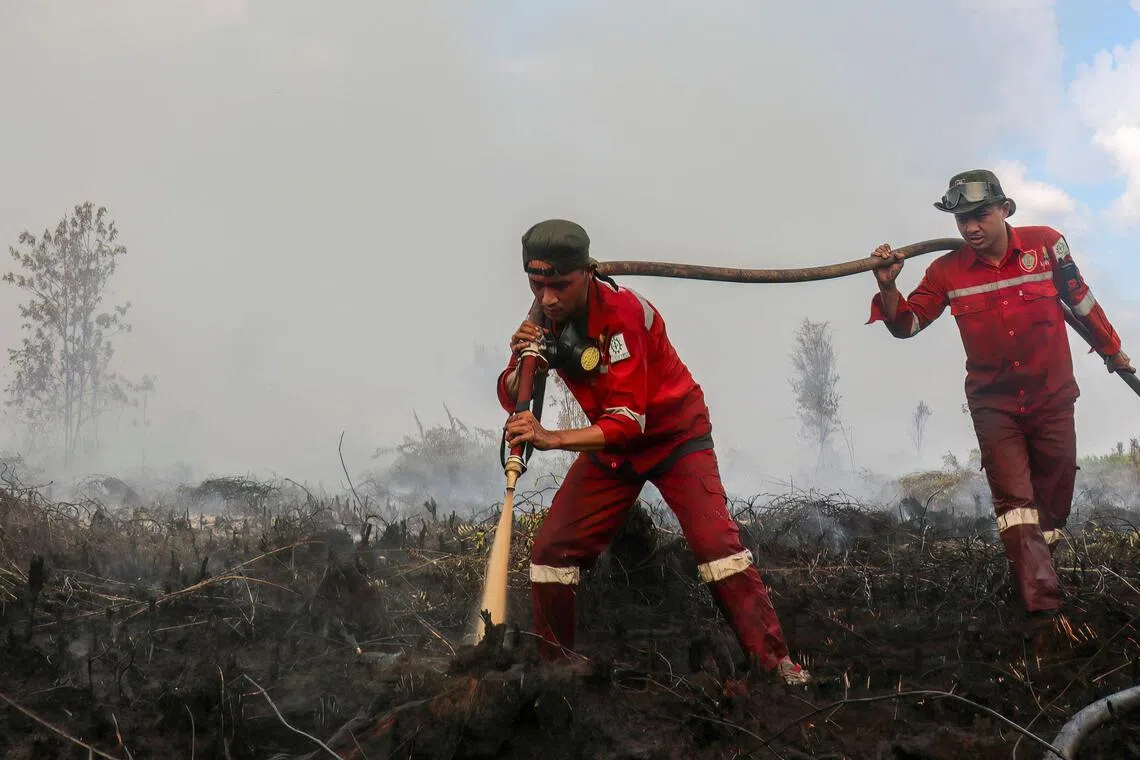 Firefighters extinguishing wildfires on peatlands covering more than 100ha in Pulang Pisau, Indonesia’s central Kalimantan province.