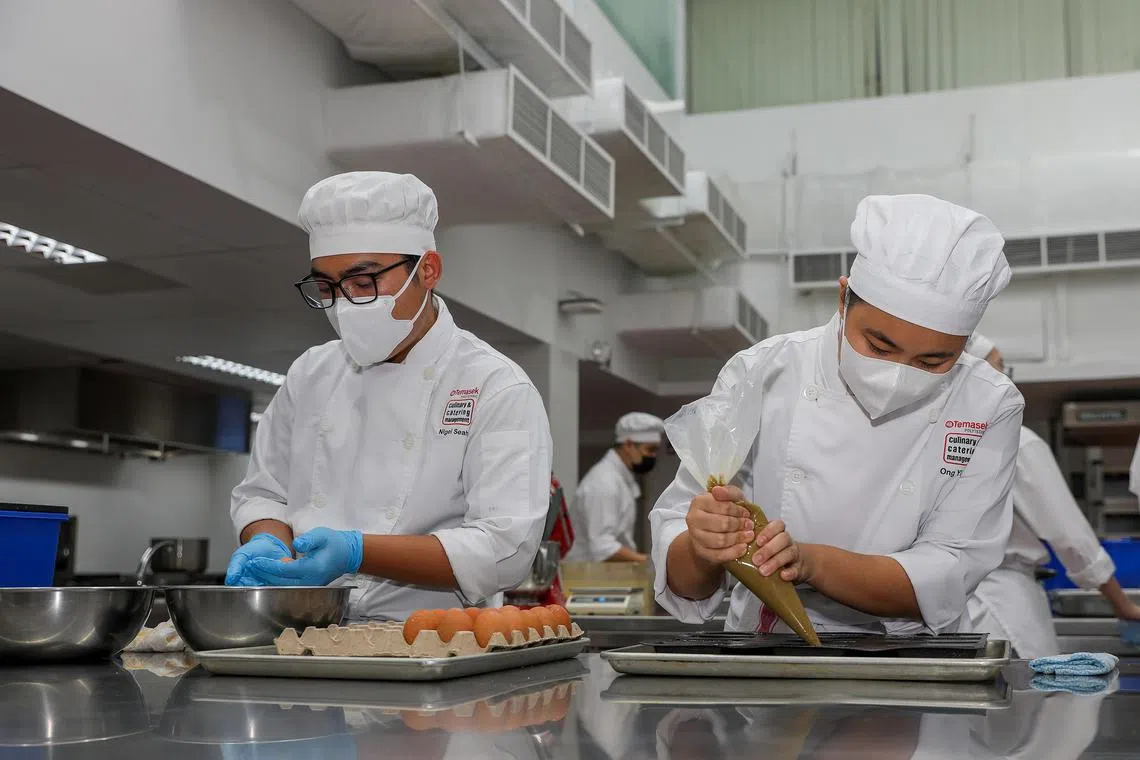 dltca - ST20250717_202523000286. Luther Lau. Pix of Ong Yi Fen,23 (Right) and Nigel Seah,19 (Left) who are year 3 students at Temasek Culinary Academy (TCA) in the baking and pastry kitchen.
ST PHOTO: LUTHER LAU
