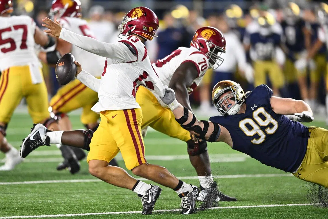 FILE PHOTO: Oct 14, 2023; South Bend, Indiana, USA; Notre Dame Fighting Irish defensive lineman Rylie Mills (99) gets a hold of the jersey of USC Trojans quarterback Caleb Williams (13) in the fourth quarter at Notre Dame Stadium. Mandatory Credit: Matt Cashore-USA TODAY Sports/File photo