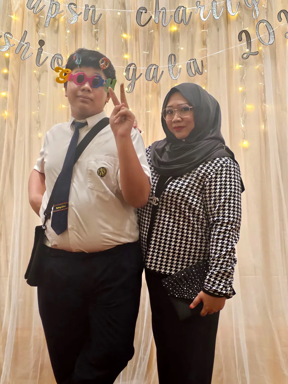 Siti Zulaiha Mohd Erfan (right) with her son, Muhammad Nafiz Sulaiman, a 19-year-old with autism.