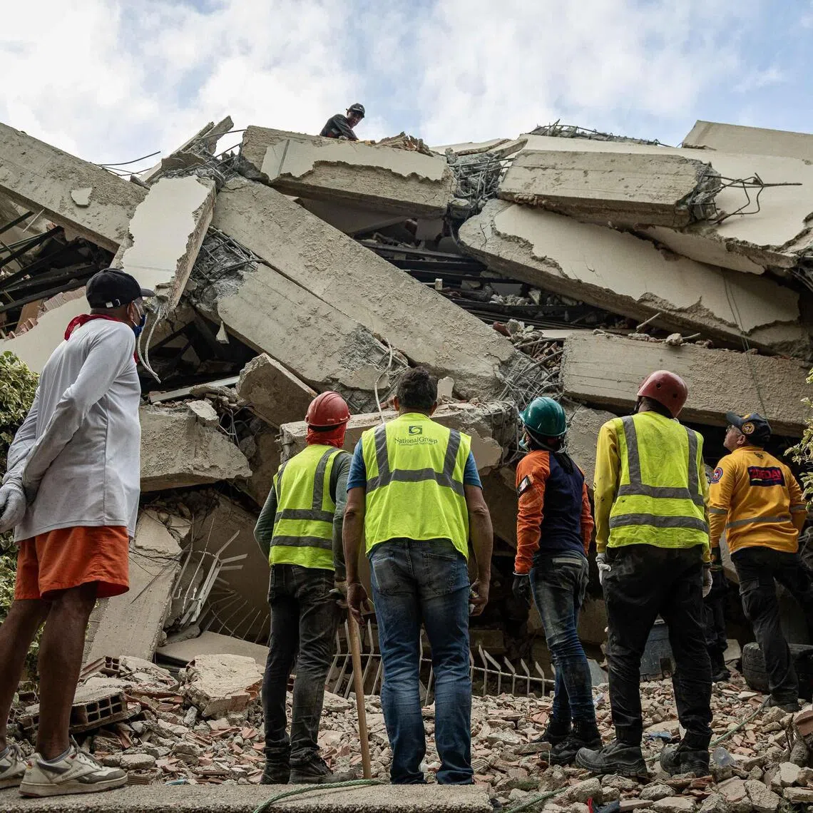 epa13070217 Rescue workers search through a building damaged by an earthquake in La Guaira, Venezuela, 27 June 2026. EPA/Henry Chirinos