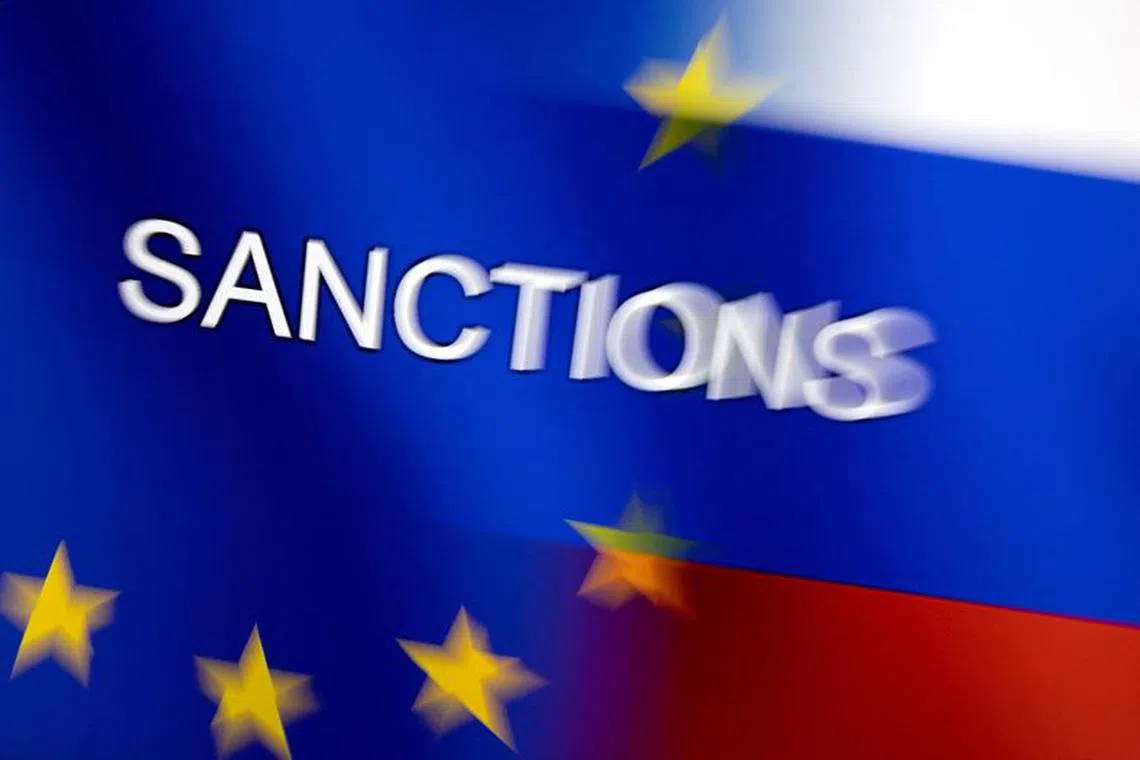 FILE PHOTO: Word \"Sanctions\" is displayed on EU and Russian flags in this illustration taken, February 27, 2022. REUTERS/Dado Ruvic/Illustration/File Photo