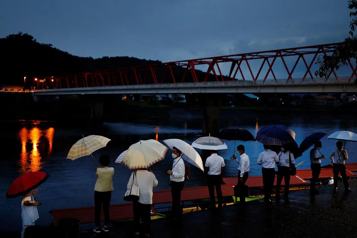 Visitors waiting to board a cormorant fishing viewing boat on the Nagara River in Oze, Seki, Japan, Sept 8, 2023. 
Ukai, or cormorant fishing, is a 1,300-old tradition largely supported by tourists nowadays, with fleets of boats allowing visitors to eat and drink as they watch the fishermen and birds downriver from Oze. 