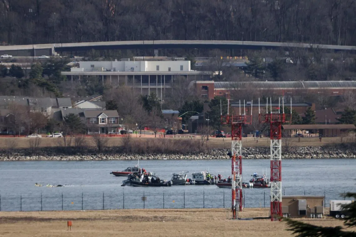 Emergency crews respond to the crash site after a passenger jet collided with a helicopter while landing at Ronald Reagan Washington National Airport on Jan 30.