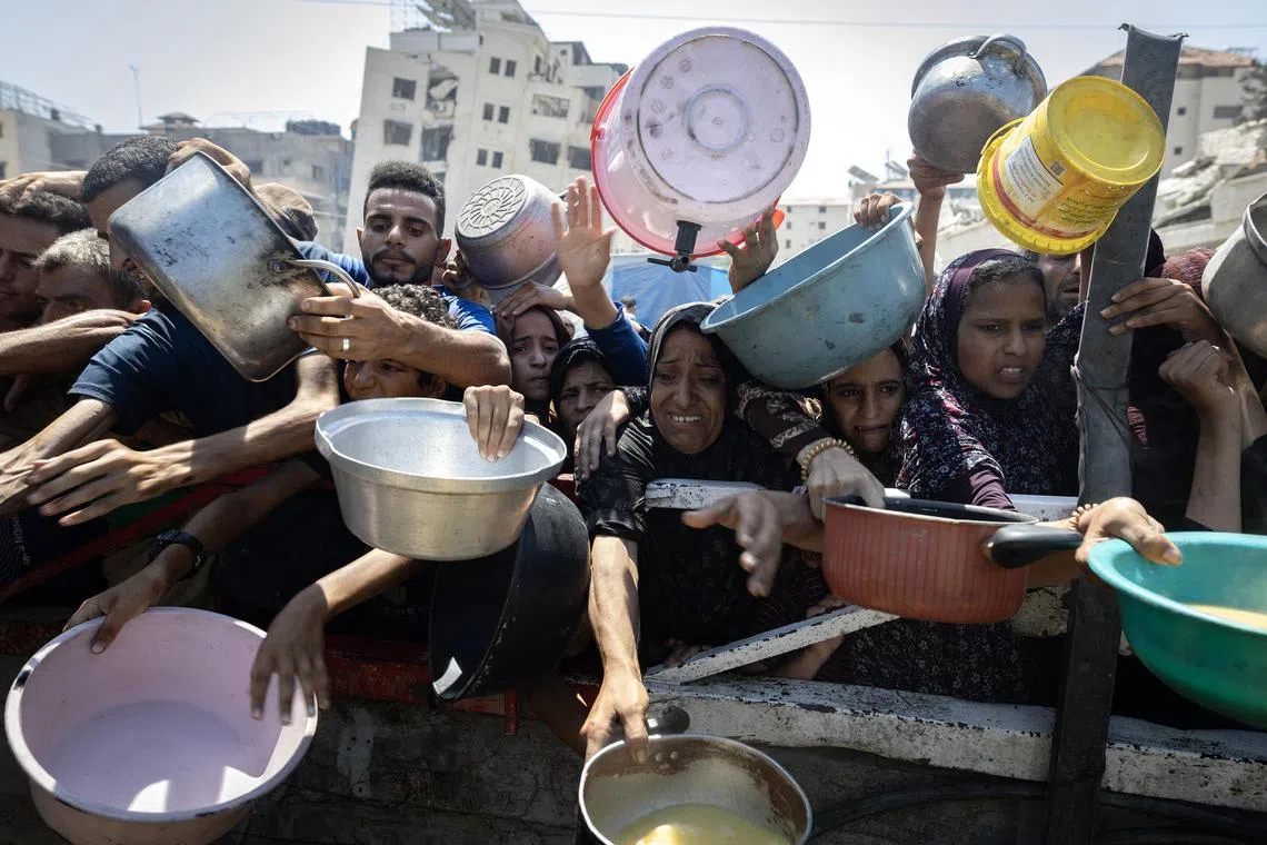 Displaced Palestinians waiting for food at a charity kitchen in Gaza City on July 23.