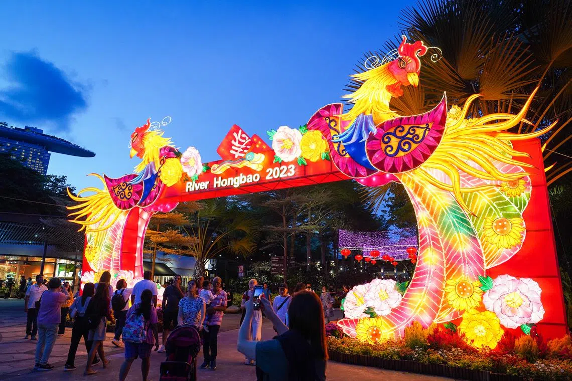Visitors walking by the Welcome Arch lantern at River Hongbao 2023 located in Gardens By The Bay on Jan 21, 2023.
