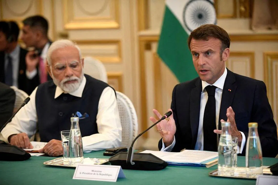 FILE PHOTO: France's President Emmanuel Macron speaks as India's Prime Minister Narendra Modi listens during a meeting at The Ministry of Foreign Affairs in Paris, France on July 14, 2023
