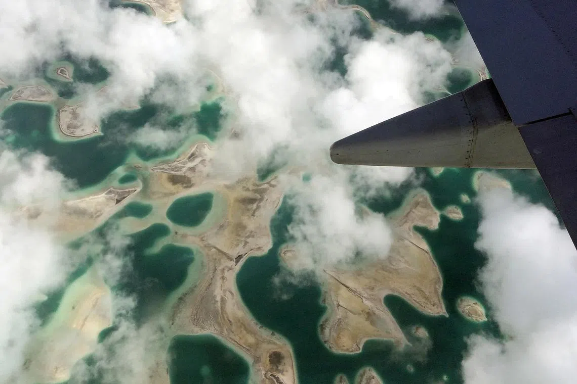 FILE PHOTO: Lagoons can be seen from a plane as it flies above Kiritimati Island, part of the Pacific Island nation of Kiribati, April 5, 2016.  REUTERS/Lincoln Feast/File Photo