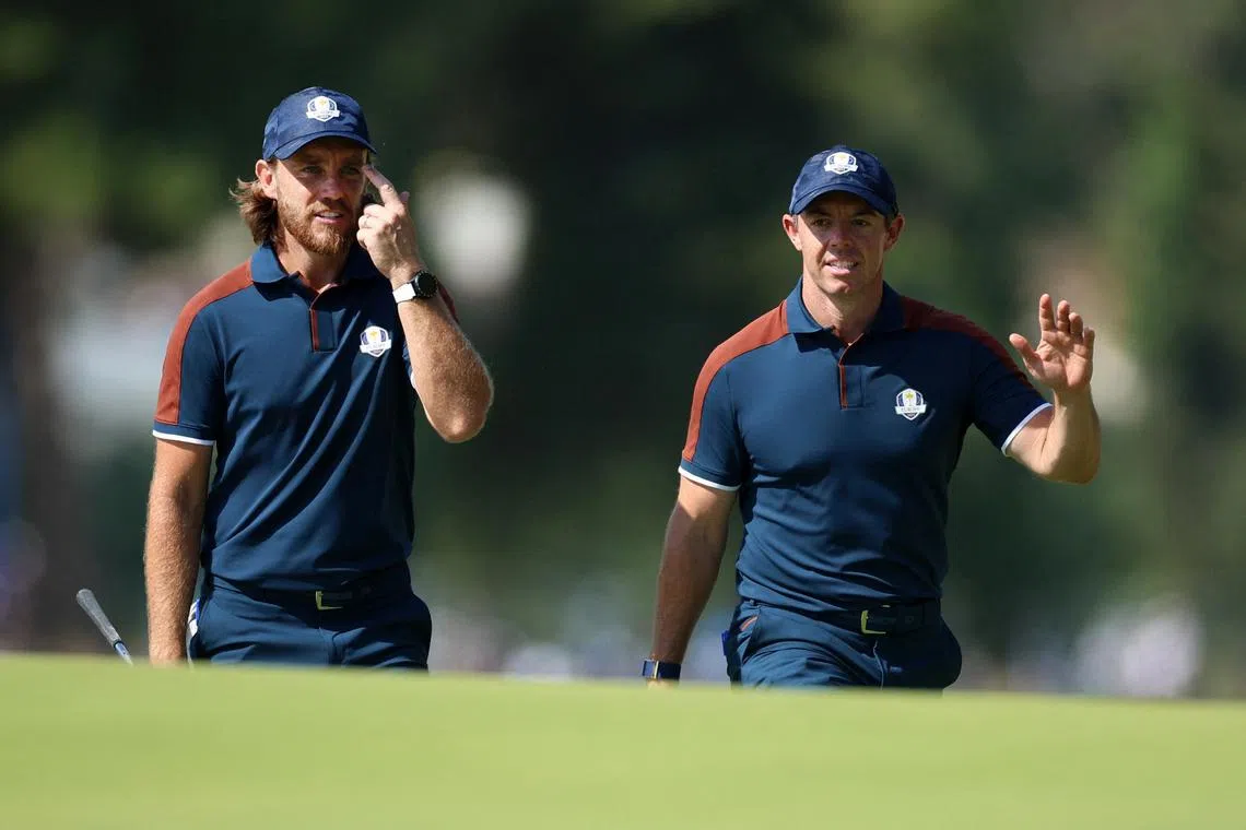 Team Europe's Tommy Fleetwood and Rory McIlroy walk up the 6th hole during a practice round.