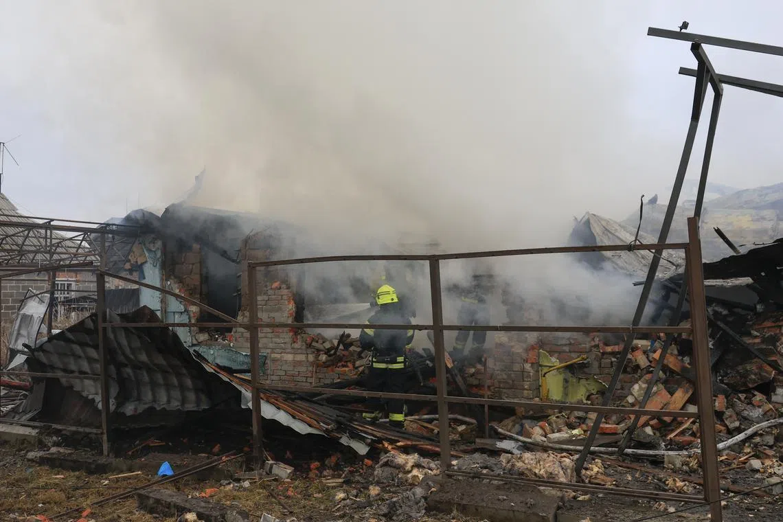 Ukrainian rescuers work at the site of an airstrike on a private building in Kharkiv, northeastern Ukraine.