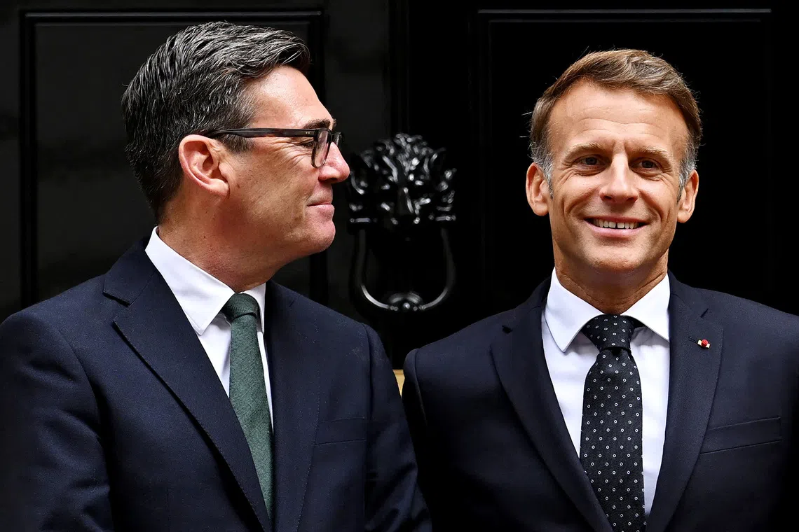 British Prime Minister Andy Burnham looks at French President Emmanuel Macron as they pose for photos ahead of a bilateral meeting at 10 Downing Street on September 03, 2026 in London, Britain. Leon Neal/Pool via REUTERS