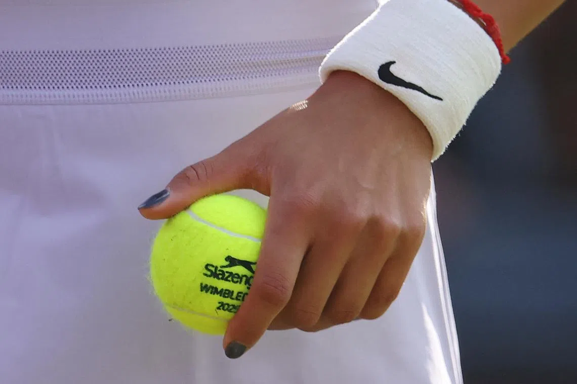 Tennis - Queen's Club Championships - Queen's Club, London, Britain - June 12, 2025 General view of Wimbledon branded tennis ball on the hand of China's Qinwen Zheng during her round of 16 match against McCartney Kessler of the U.S. REUTERS/Toby Melville/File Photo