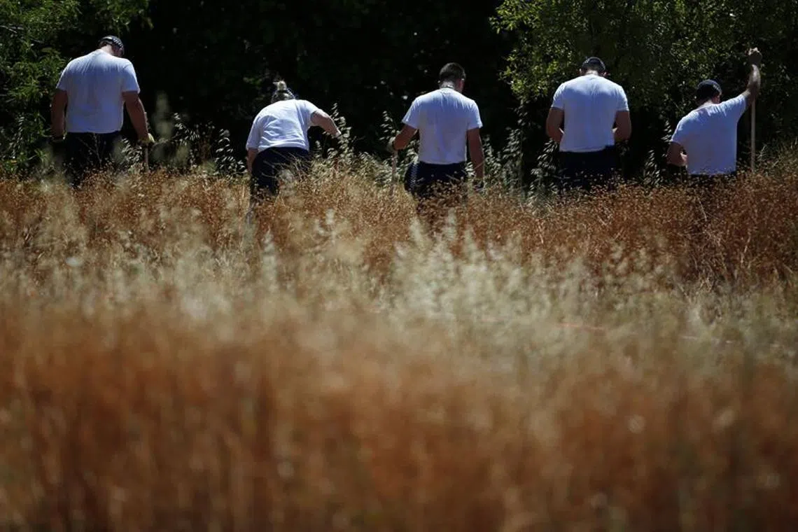 FILE PHOTO: Members of Scotland Yard work at an area during the search for missing British girl Madeleine McCann in Praia da Luz, near Lagos, June 5, 2014.REUTERS/Rafael Marchante/File Photo